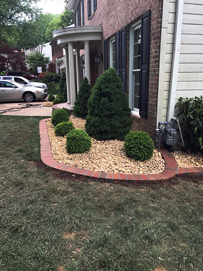 shrubery bed with river rock burke va